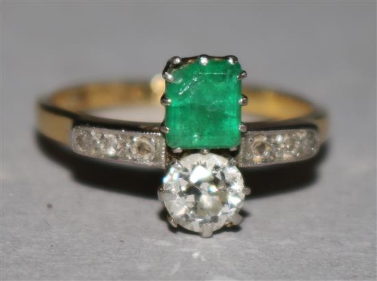 An 18ct gold and platinum, emerald and diamond crossover ring, size J.